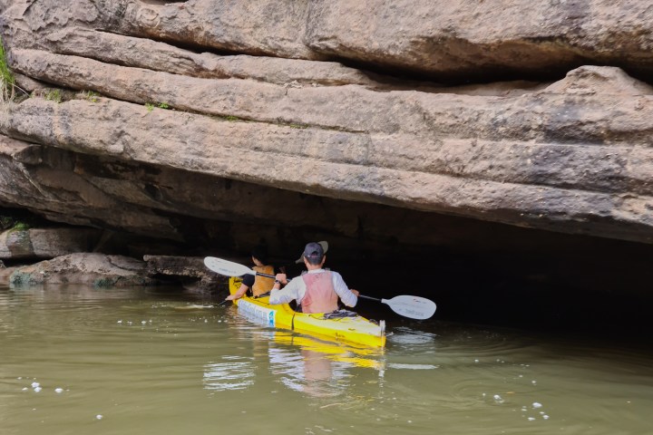 a person sitting on a rock in a pool of water