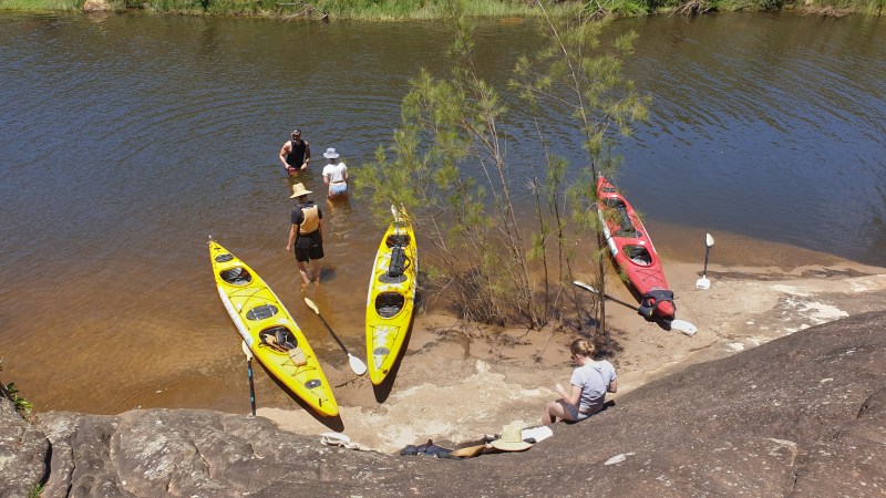 a man standing next to a body of water