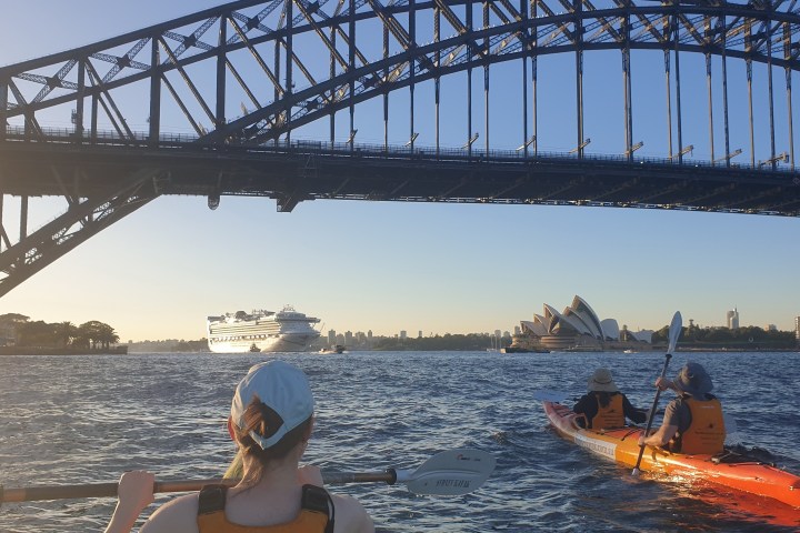 a train crossing a bridge over a body of water