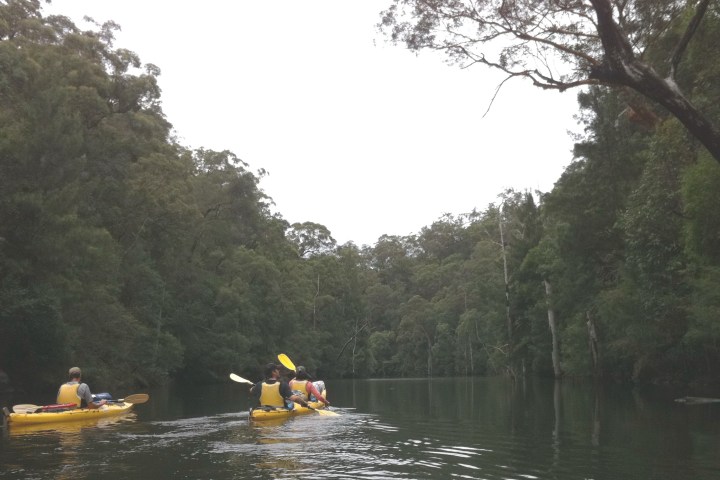 a group of people in a boat on a body of water