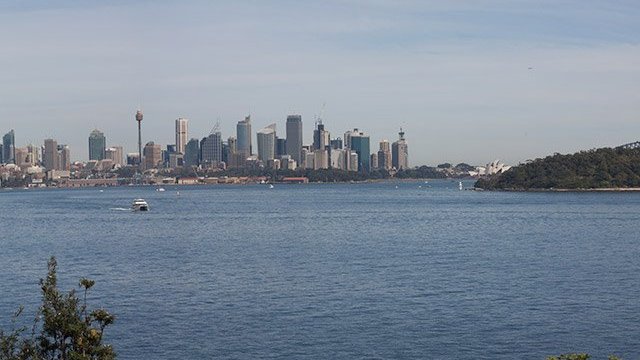 a large body of water with a city in the background