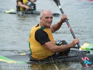 about-image-01 a man rowing a boat in the water