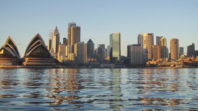 a body of water with a city in the background