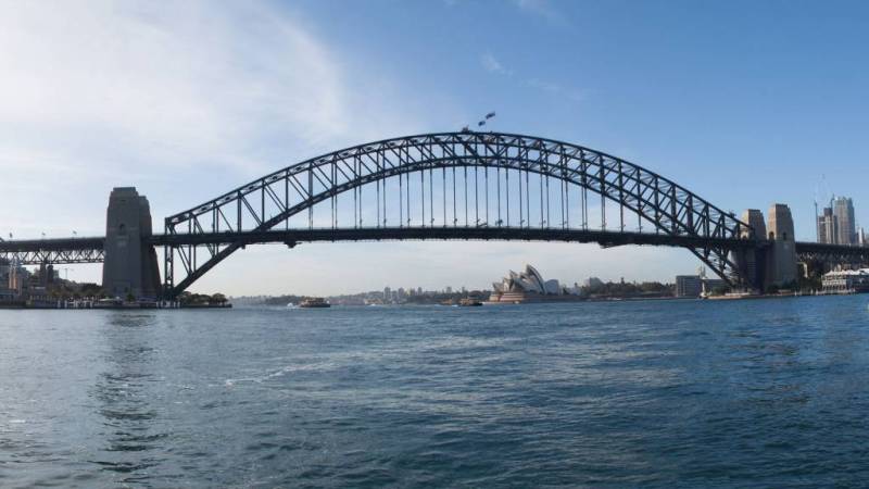a train crossing Sydney Harbour Bridge over a body of water