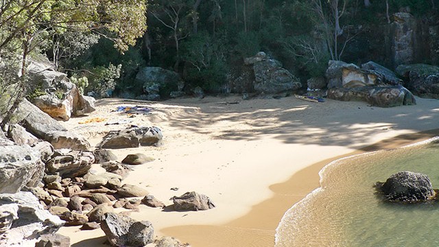 a group of people on a rocky beach